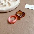 Detail showing the marbled texture and amber finish of these acrylic geometric rings - Irregular Geometric (6021388831368)