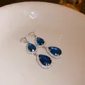Elegant silver needle drop earrings featuring blue teardrop crystals with halo accents - Double Teardrop (13)