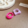 Close-up view of irregular marble pattern acrylic rings in pink and lavender purple colors. - Irregular Geometric (6021388831366)