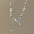 Detailed view of a dainty butterfly pendant necklace with elegant pearls and sparkling crystals - Style 1