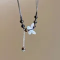 Detailed view of an elegant silver butterfly pendant necklace accented with tiger eye beads - Style 45 (Butterfly)