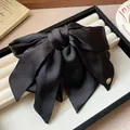 Detailed view of the elegant large black satin bow hair claw clip with a gold metal charm. - Hair Claw No. 3 (3#) / Black