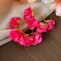 Detailed close-up of bright pink chiffon flower hoop earrings with golden leaf accents - Silver Earring Post Style / Gold-Rose Red