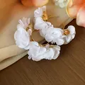 Close-up of white chiffon flower C-shape hoop earrings with gold leaf details - Silver Earring Post Style / Gold-White