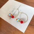 Close-up detail of summer style colorful resin bead hoop earrings with sweet temperament - Colorful Resin Bead Style (HE27658) / Gold with Red and Blue Polka Dot
