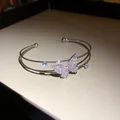 Detailed close-up of double-layer silver cuff bracelet with pink crystal butterfly - Silver