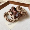 Detailed view of four fabric hair ties featuring houndstooth and heart patterns. - Set of 4 / Brown