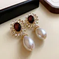 Gros plan sur des boucles d'oreilles vintage avec cristal rouge et perle en goutte. - Boucles d'Oreilles Tige en Argent-Or-Rouge-Blanc