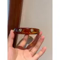 Bracciale rigido vintage in resina ambrata con strass scintillanti incastonati top - Ambra