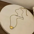 Elegant French style gold bean pendant necklace showcased on a minimalist white display board - Gold Bean Pendant Necklace (11#)