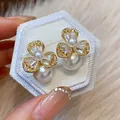 Close-up of elegant flower pearl earrings with sparkling zircons on white velvet box - Elegant Flower (WE5690) / 925 Silver Needle / Gold