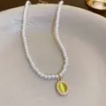 Elegant French style pearl necklace featuring a light green cat's eye stone pendant - White Oval Pearl Necklace (33#)