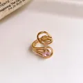 Detail view of a gold stainless steel open ring with a pink zircon in hollow floral design - 41# Ring - Gold - Pink