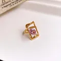 Detail view of a gold stainless steel open ring with hollow frame and pink oval zircon stone - 40# Ring - Gold - Pink