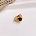 Detailed macro view of a gold stainless steel open ring featuring a large black zircon stone. - 26# Ring - Gold - Black