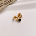 Detail view of an elegant gold stainless steel open ring featuring a black heart zircon - 31# Ring - Gold - Black