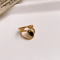 Detailed view of an open hollow gold stainless steel ring featuring a black oval gemstone - 27# Ring - Gold - Black