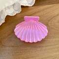 Macro view of pink pearlescent shell-shaped hair claw clip with delicate pleated texture - Small Shell Claw Clip / Small / Pink