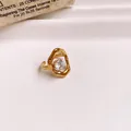Macro detail of a gold hollow flower open ring with a sparkling zircon stone - Round Style (2#) / Gold