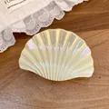 Close-up of pearlescent shell hair claw with iridescent finish on wood background. - Large Shell Claw Clip / Large / Yellow