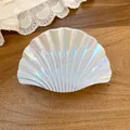 Detailed close-up of an iridescent white shell-shaped hair claw clip with pleated texture - Large Shell Claw Clip / Large / Cyan
