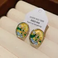 Close-up of floral oil-drop earrings with pearls and silver needles in a jewelry box. - Yellow (HE19017)