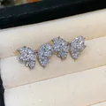 Macro view of delicate butterfly bowknot stud earrings with sparkly pavé set zircons. - Silver