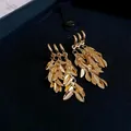 Detailed close-up view of elegant gold leaf fringe dangle earrings in a jewelry box - Gold Wheat Tassel (73#)