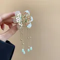Detailed view of a vintage butterfly hair claw clip with elegant golden tassels. - Butterfly Tassel Claw / Gold-Stamen Style