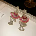 Detailed view of luxury gold fan-shaped earrings with pink and white sparkling rhinestones - Earrings Only / Pink