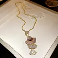 Close-up of gold fan-shaped pendant necklace with colorful crystals and baguette stones. - Chain Only / Purple