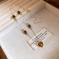 Detailed view of vintage gold necklace featuring tiger's eye beads and heart pendant - Heart Pendant / Gold Brown