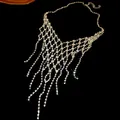 Stunning silver-toned rhinestone geometric tassel necklace with sparkling fringe detail. - Silver