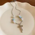 Close-up of elegant silver necklace with bow pendant, delicate pearls and blue stars - Silver (Blue Star)