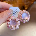 Detailed view of elegant pink resin floral stud earrings with purple center - Pink