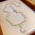 Detail shot of a French light luxury pearl necklace with an irregular baroque pearl pendant. - Round Style / Pearl White