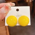 Dettaglio di orecchini a lobo sferici gialli lucidi con perno in argento sterling - Orecchino a Sfera / Giallo