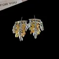 Eleganti orecchini con nappine a foglia in oro e argento, perfetti per un look raffinato. - Ago D'argento N. 30 - Oro - Argento