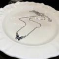 Elegant silver-tone butterfly necklace with blue enamel and sparkling rhinestone - Silver-Blue Gradient