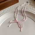 Elegant pink beaded necklace featuring a delicate bow design and white pearls for SKU - Pink-Square Bead Pearl