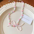 Pastel beaded flower necklace featuring a dainty pink seed bead bow-shaped pendant - Multicolor-Pink White