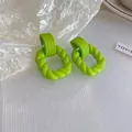 Close-up of vibrant lime green twisted resin hoop earrings with a matte spray finish - 3# Green - Bow