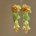 Close-up of Mori-style floral earrings with yellow roses and green beaded tassels - 28# Green - Orange