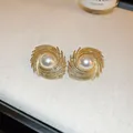 Elegant gold-finished pearl stud earrings with a vintage textured swirl design. - Gold Wrapped Pearl Silver Post Earrings - No. 115