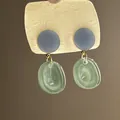 Close-up of forest style resin earrings with green translucent dangles and blue studs. - 43# Light Green