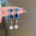 Elegant vintage royal style blue crystal dangle earrings with white pearl drop detail - Earrings (Silver Earring Post) / Silver-Blue