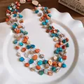 Detailed view of colorful irregular shell pieces on multi-layered necklace strand - Blue-Orange