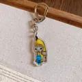 Close-up of a cute acrylic Banana Cat keychain drinking from a blue cup - Blue Bottle Banana Cat / Silver