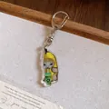 Close-up of a cute acrylic Banana Cat keychain with a green drink cup on white background. - Green Bottle Banana Cat / Silver