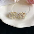 Detailed view of elegant French style iridescent flower earrings with small rhinestones - Rainbow